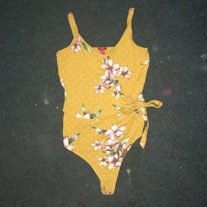 This is a bodysuit from the store Guess!